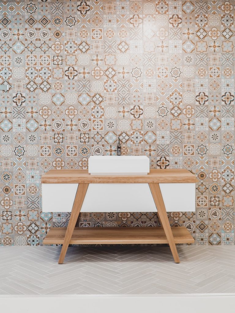 brown wooden table beside white and black wall