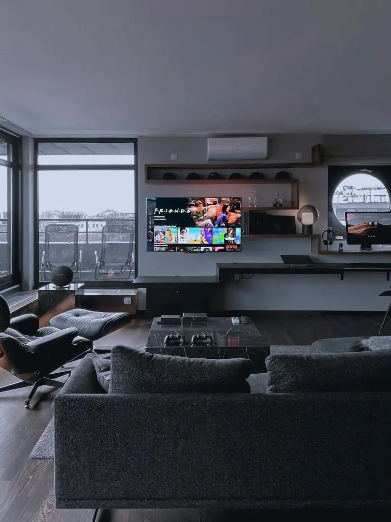 black flat screen tv turned on near window