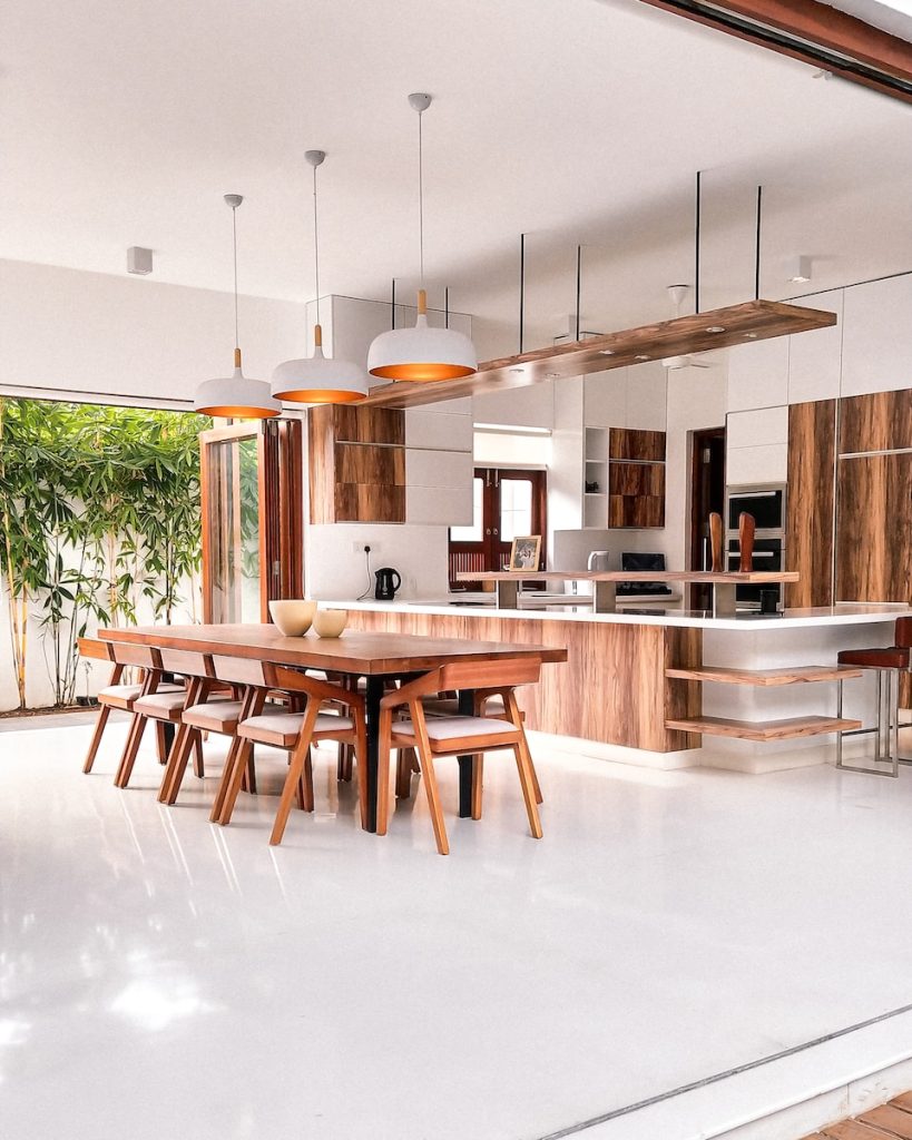 a kitchen with a table, chairs and a refrigerator