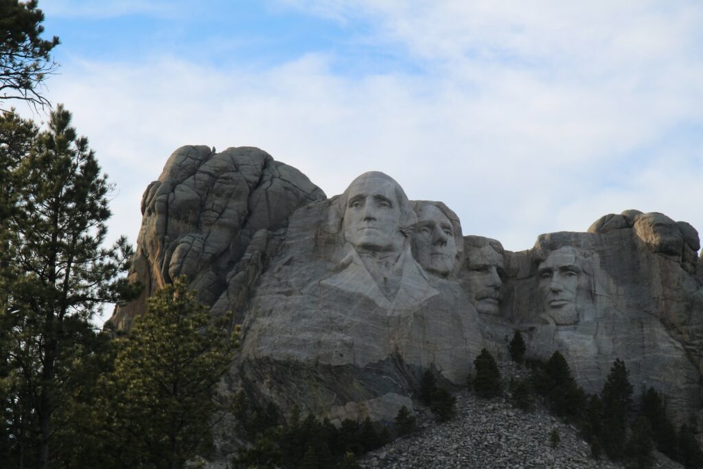 gray rock formation under white clouds during daytime