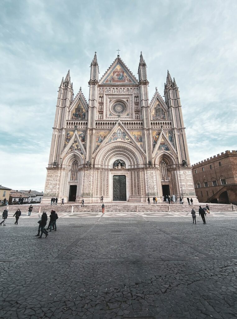 a group of people standing in front of a cathedral