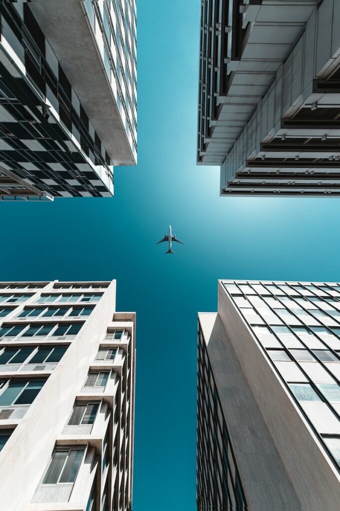 white bird flying over the building during daytime