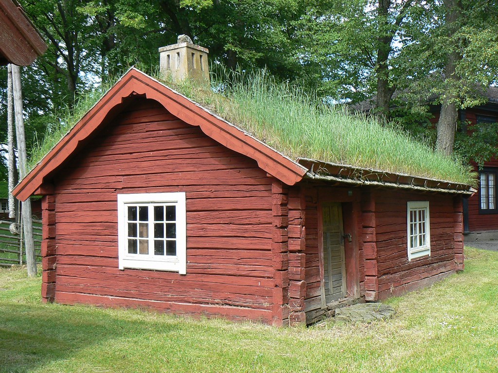 Traditional red wooden house with green grass roof, Sweden