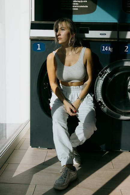 Young woman leaning on washing machine