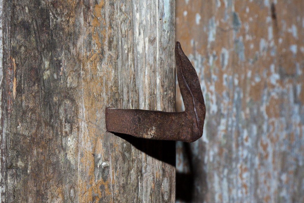 Bent nail stuck into wooden frame