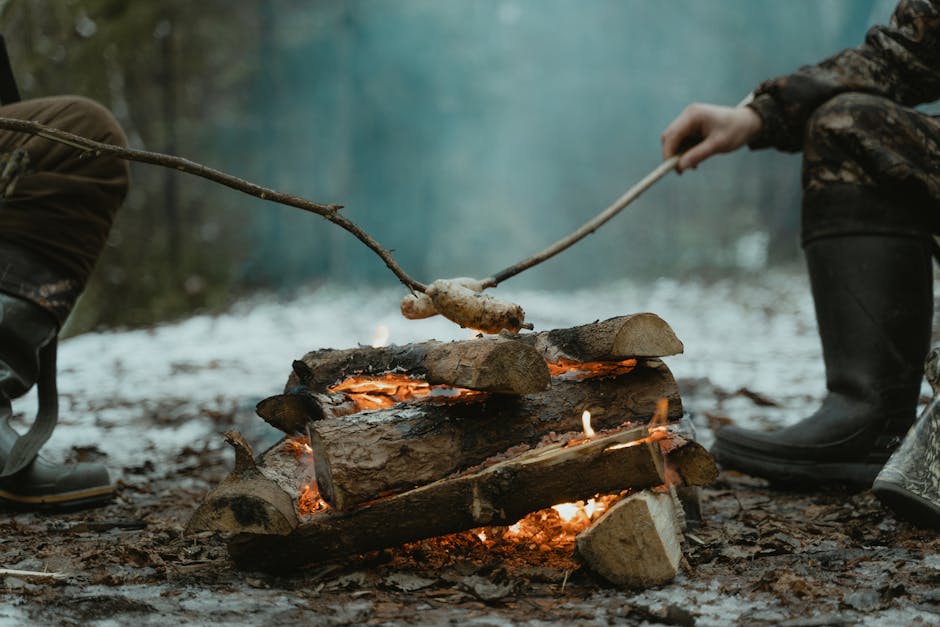 Person Holding a Stick on a Wood Burning