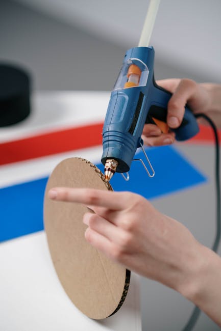 Close-up of Person Making Crafts with the Use of a Hot Glue Gun 