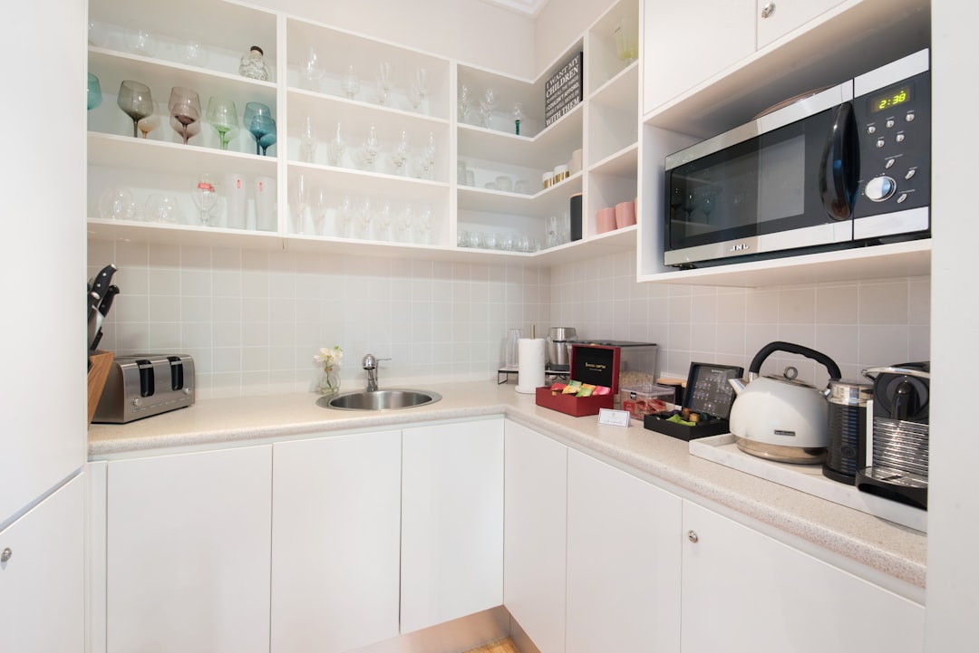 a kitchen with white cabinets and a microwave