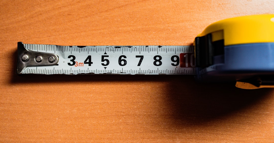 A tape measure is on a wooden table