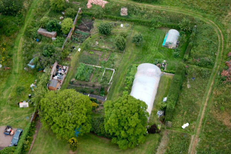 Someone's backyard greenhouses, etc.