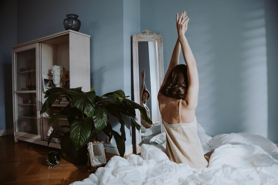 mirror,size,style Photo of a Woman Raising Her Hands while Looking at the Mirror