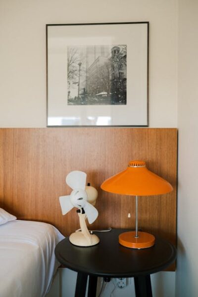 Mid Century Modern Home Design Characteristics Old-fashioned Fan and Lamp on a Table on a Bedroom