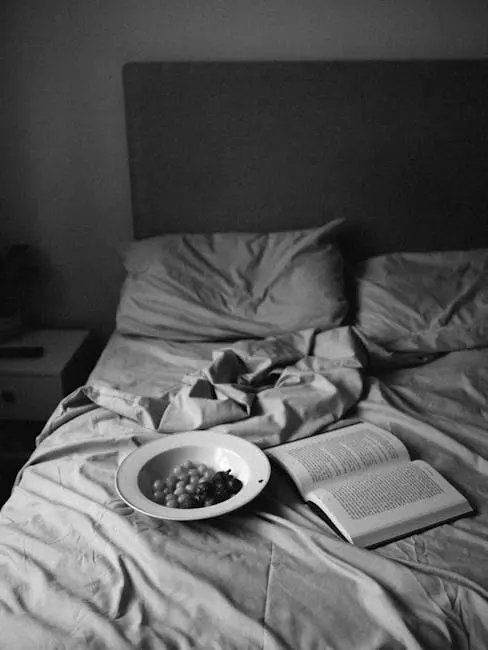 Add Flair to Your Bedroom With a Soft Bed Frame Grapes on a Plate and an Open Book on a Bed 