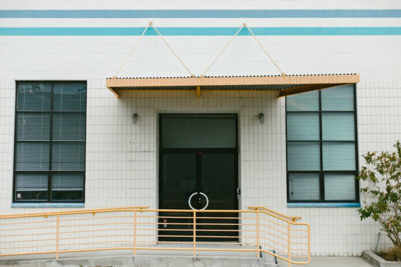 Closed door of white concrete building