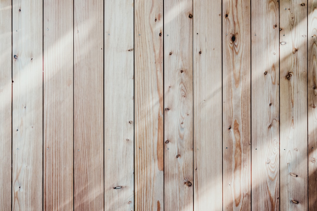 A close-up of a wooden wall with a light shining on it