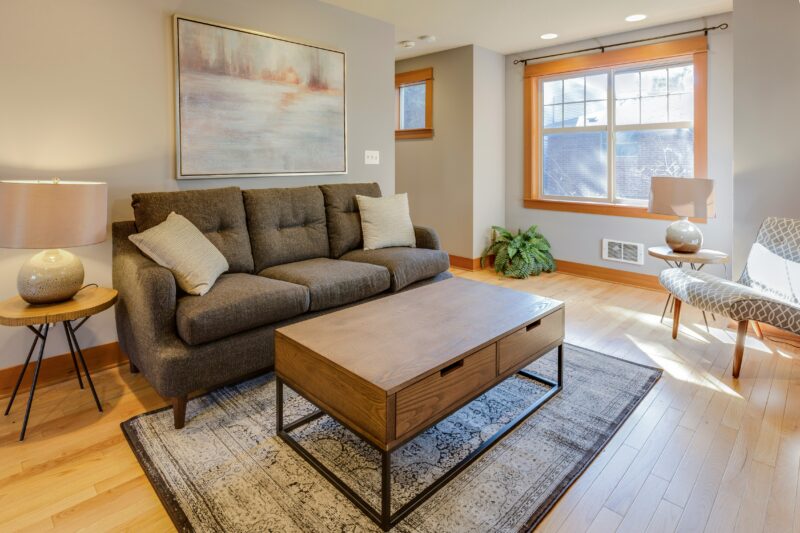 brown couch with two white throw pillows