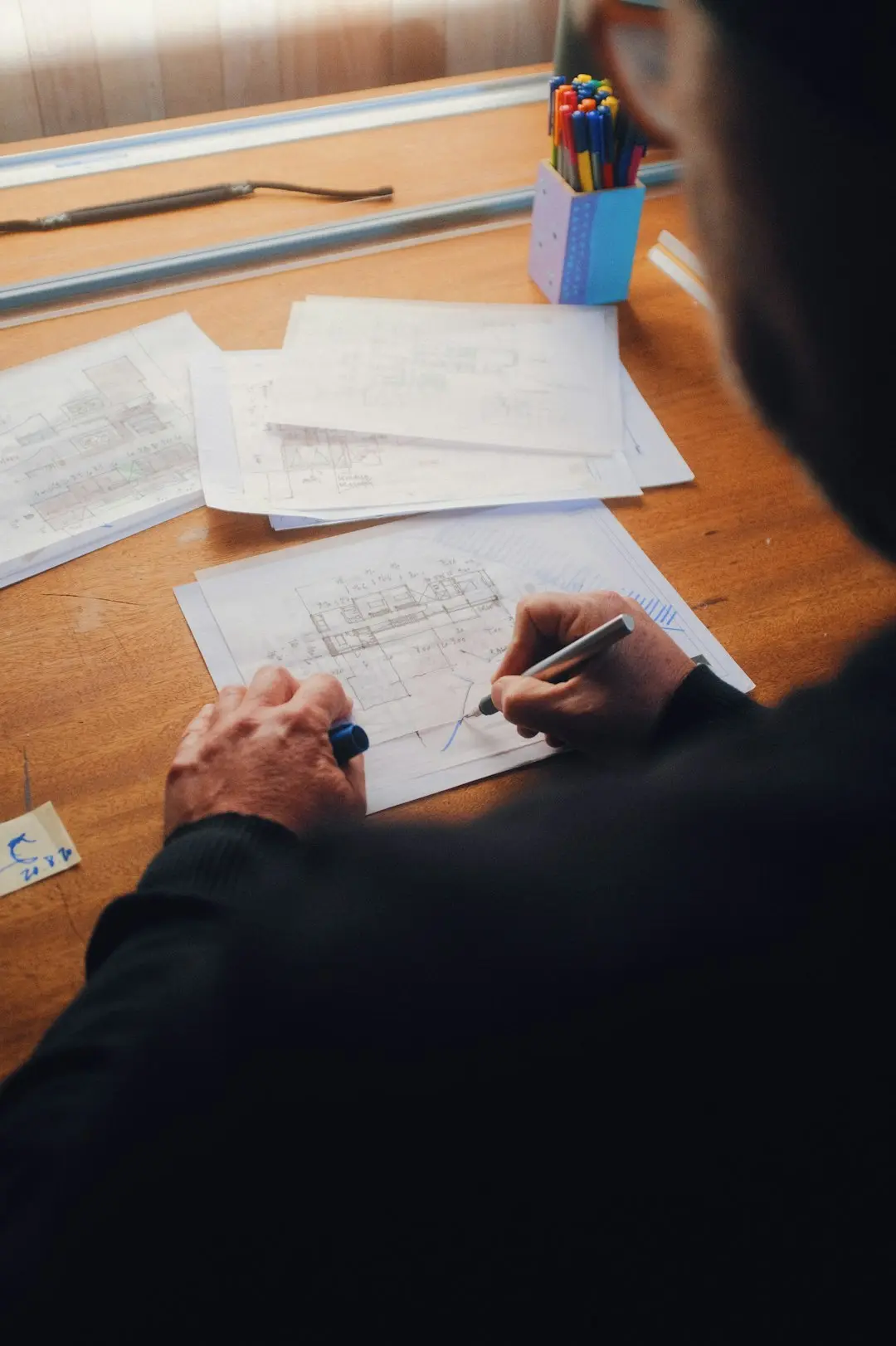 A person writing on white paper