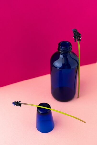 A blue glass bottle with a flower