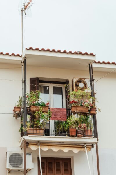 a balcony with potted plants and a fan