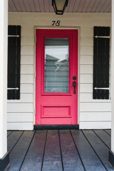 a red front door on a white house