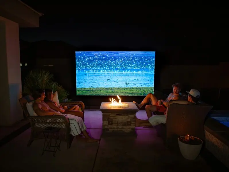 A group of people sitting around a fire pit