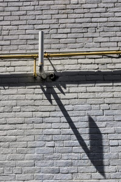 a shadow of a person on a brick wall