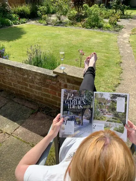 a person lying on the ground reading a book