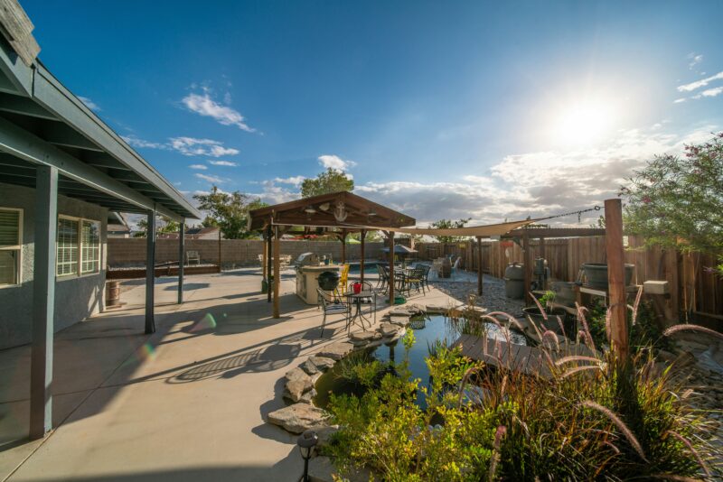 a backyard with a small pond and a gazebo