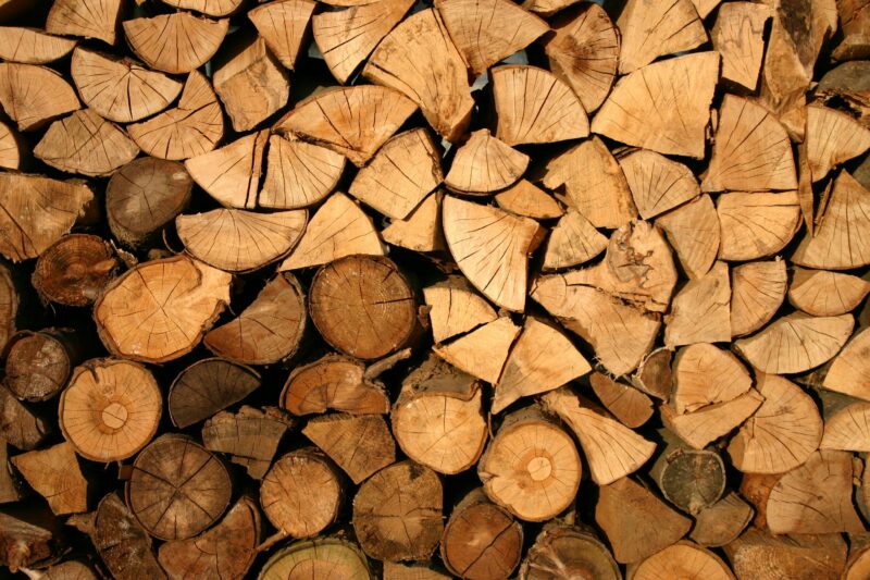 Close-up of stacked firewood showing natural textures and wood grain patterns.