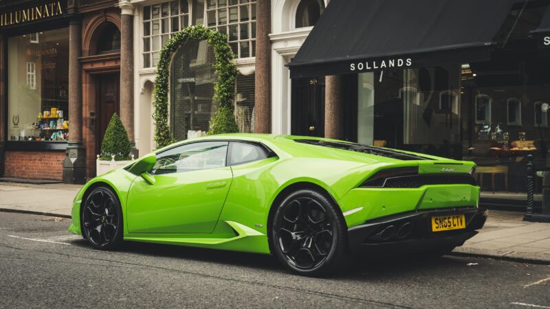 A vibrant lime green Lamborghini parked on a London street, showcasing luxury and style.