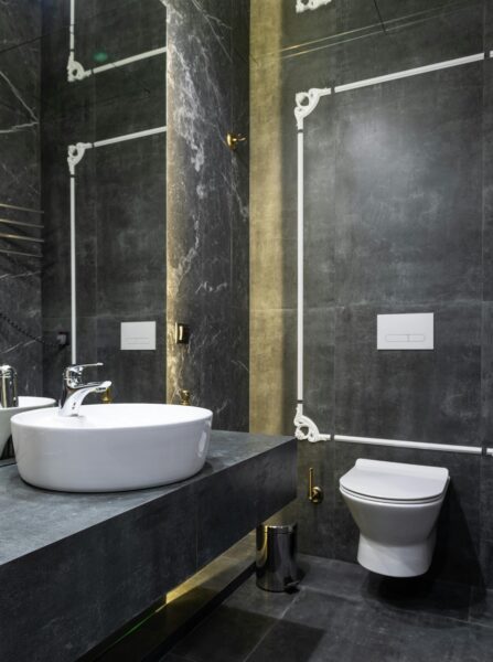 Elegant modern bathroom featuring marble walls and contemporary sink.