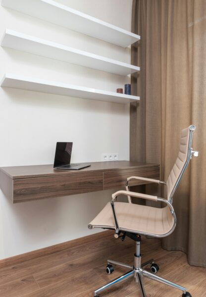 Stylish home office setup with a modern chair and floating desk, perfect for remote work.