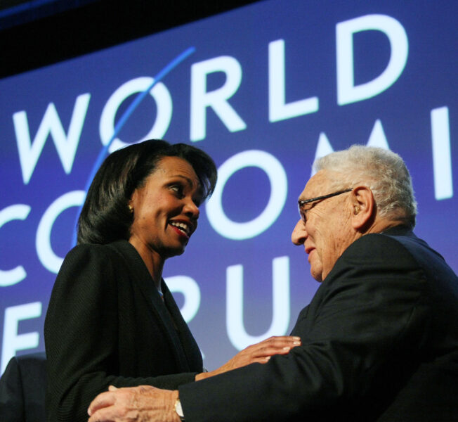 Condoleezza Rice and Henry Kissinger at World Economic Forum discussing net worth