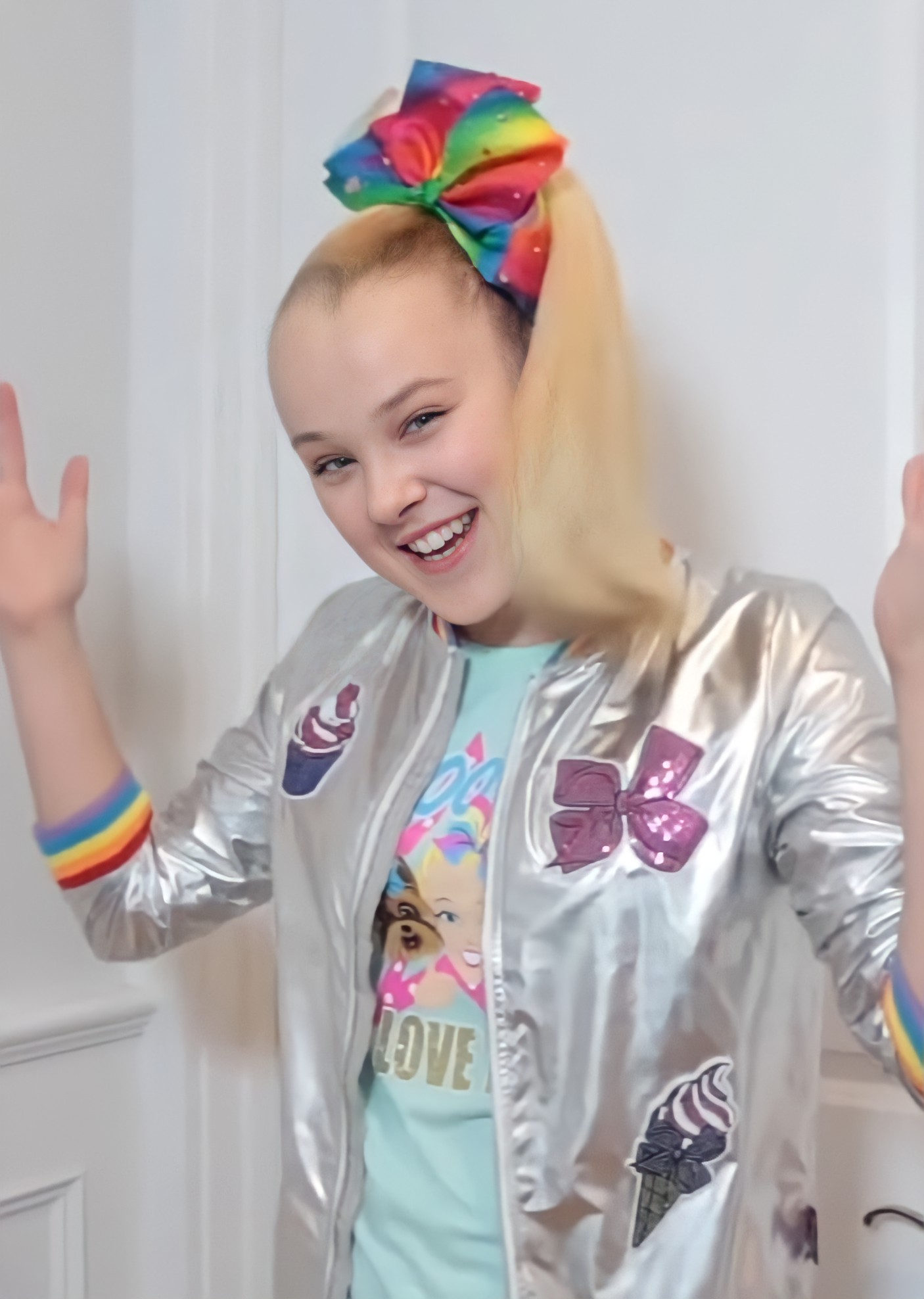 JoJo Siwa smiling, wearing a colorful outfit