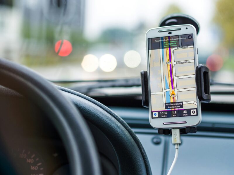 Smartphone mounted in car using GPS for navigation and directions.