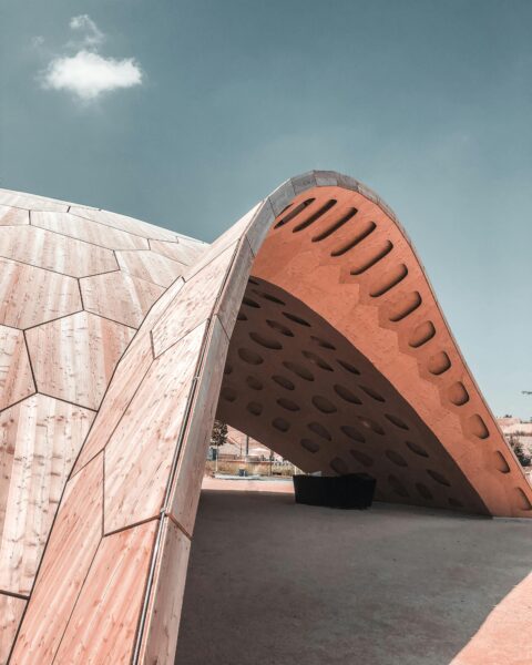 Contemporary wooden architectural structure under a clear sky in Germany.