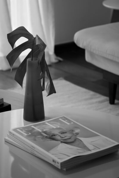 Elegant interior with a modern vase and magazine in black and white.