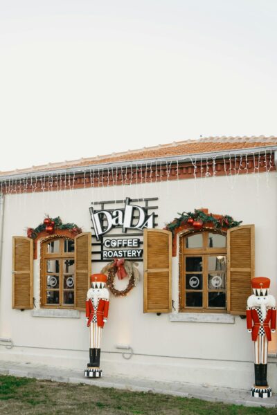 Charming coffee roastery exterior with Christmas decorations and nutcracker figures.