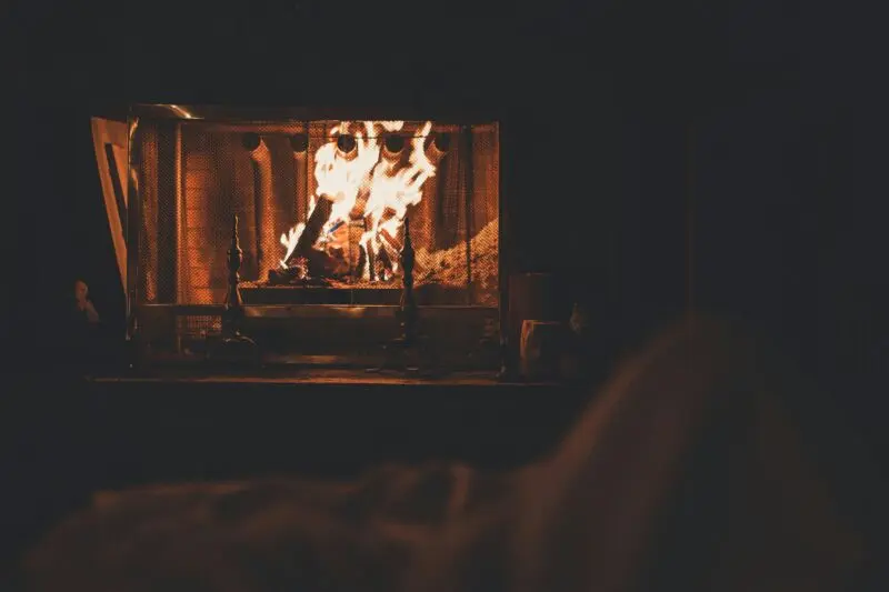 cozy indoor fireplace with vivid flames, warm relaxing winter ambiance