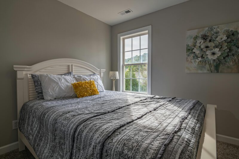 A warm, inviting bedroom with a double bed and natural light streaming in.