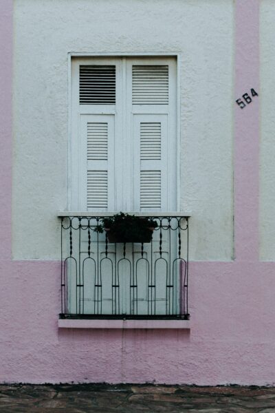 Captivating pastel facade with shutters in Aracati, Brazil, showcasing elegant architecture.