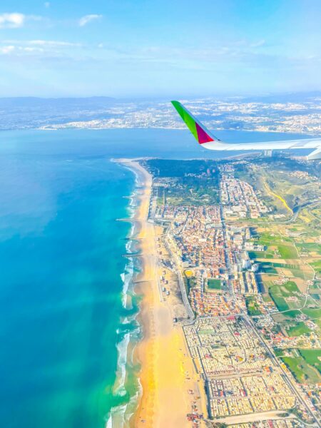 Stunning aerial shot of Cancún's coastline, showcasing beaches and cityscape from a plane.