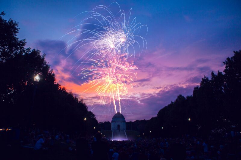 Colorful fireworks light up the sky over the McKinley Monument during a festival evening.