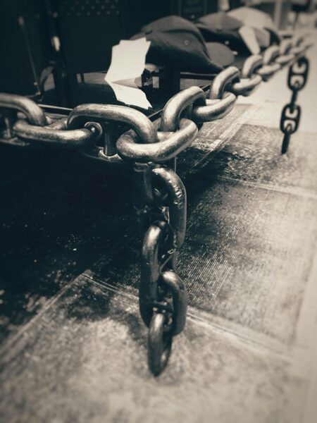 Artistic grayscale close-up of industrial steel chains creating a moody atmosphere.