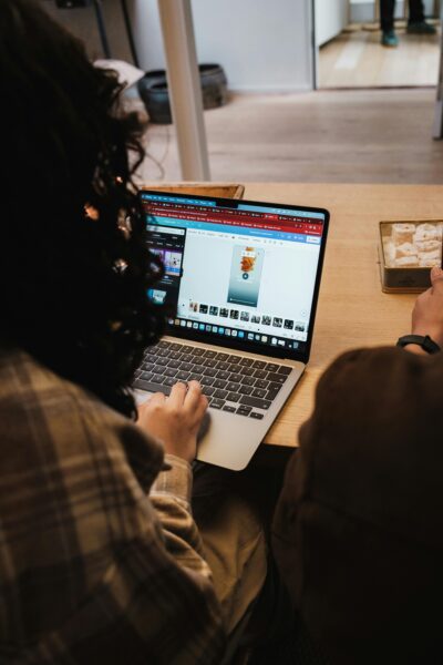 Woman focused on laptop work in a cozy indoor setting, ideal for remote work themes.