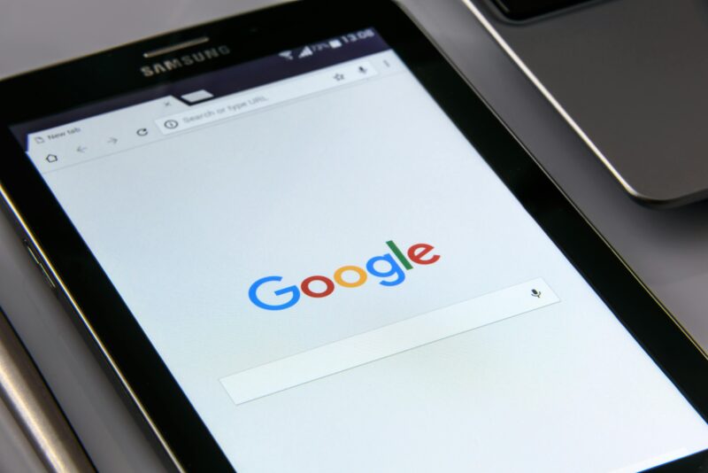 Close-up of a tablet displaying Google's search screen, emphasizing technology and internet browsing.