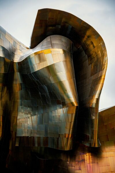 Close-up of a modern metallic structure in Seattle, showcasing futuristic design and golden tones.