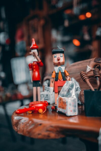 Charming display of wooden toys and Pinocchio figurines on a table indoors.