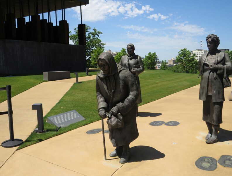 Statues at a memorial park in Montgomery, AL, honoring historical figures.