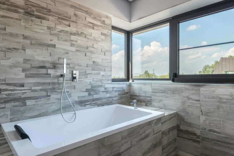 Bright and clean bathroom with a modern bathtub and large windows